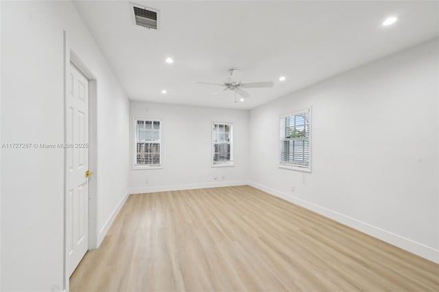 spare room with ceiling fan and light wood-type flooring