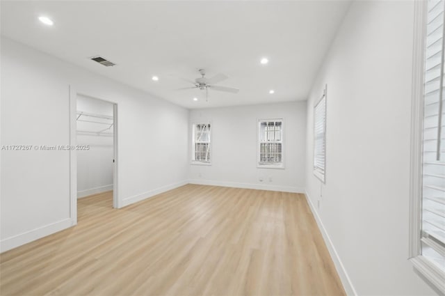 empty room featuring ceiling fan and light wood-type flooring