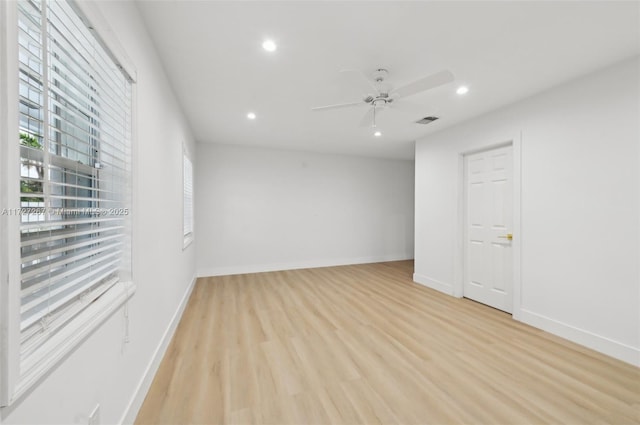 spare room featuring light hardwood / wood-style floors and ceiling fan