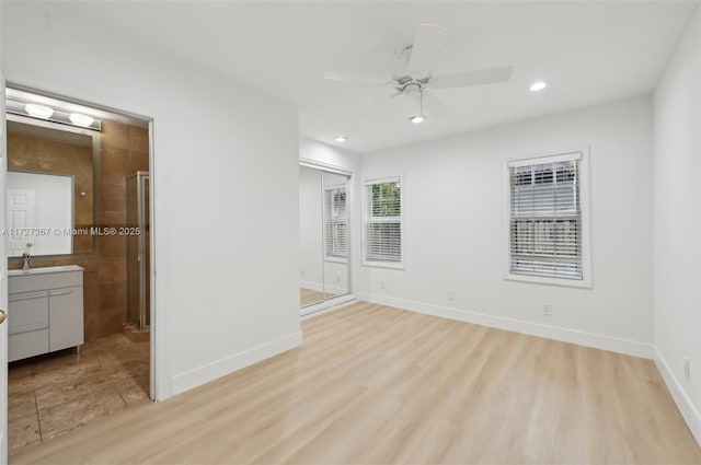 spare room with ceiling fan and light hardwood / wood-style floors