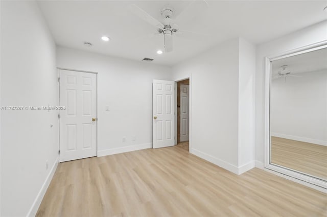 unfurnished bedroom featuring ceiling fan, a closet, and light hardwood / wood-style floors