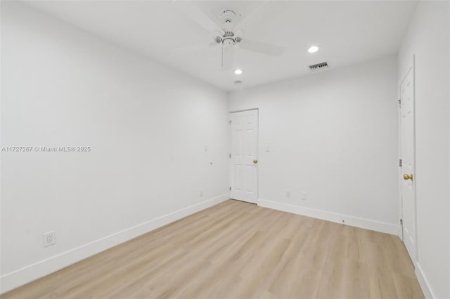 unfurnished room with ceiling fan and light wood-type flooring