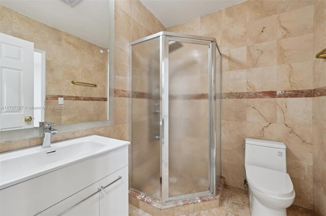 299 S Biscayne River Dr, Miami, FL 33169 - bathroom with tile walls, vanity, a stall shower, and toilet