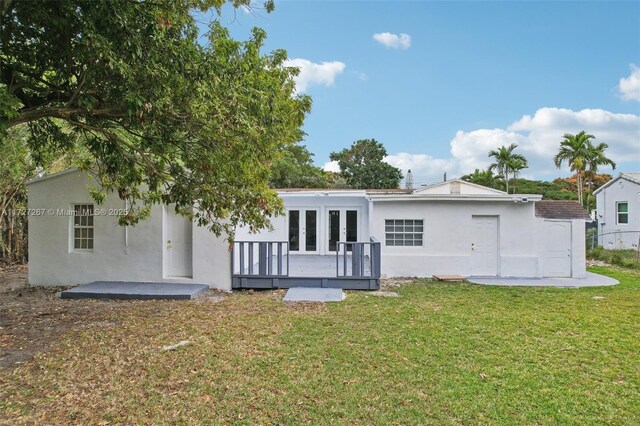 299 S Biscayne River Dr, Miami, FL 33169 - back of house with french doors, stucco siding, a lawn, and a wooden deck