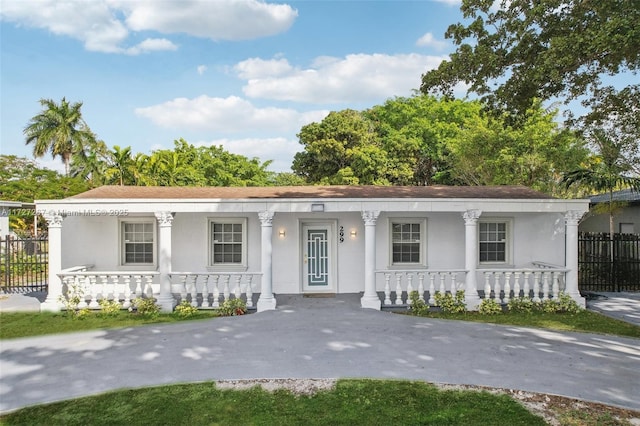 299 S Biscayne River Dr, Miami, FL 33169 - view of front of property with covered porch, stucco siding, and a shingled roof