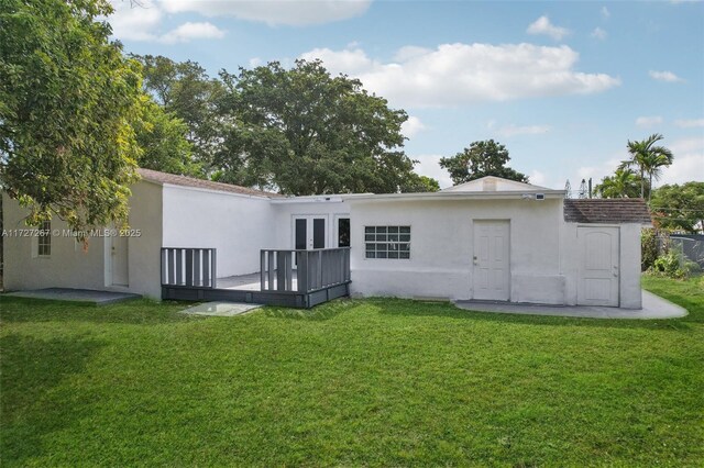 299 S Biscayne River Dr, Miami, FL 33169 - back of property with stucco siding, a yard, and french doors