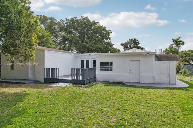 299 S Biscayne River Dr, Miami, FL 33169 - rear view of property with stucco siding, a yard, a deck, and french doors