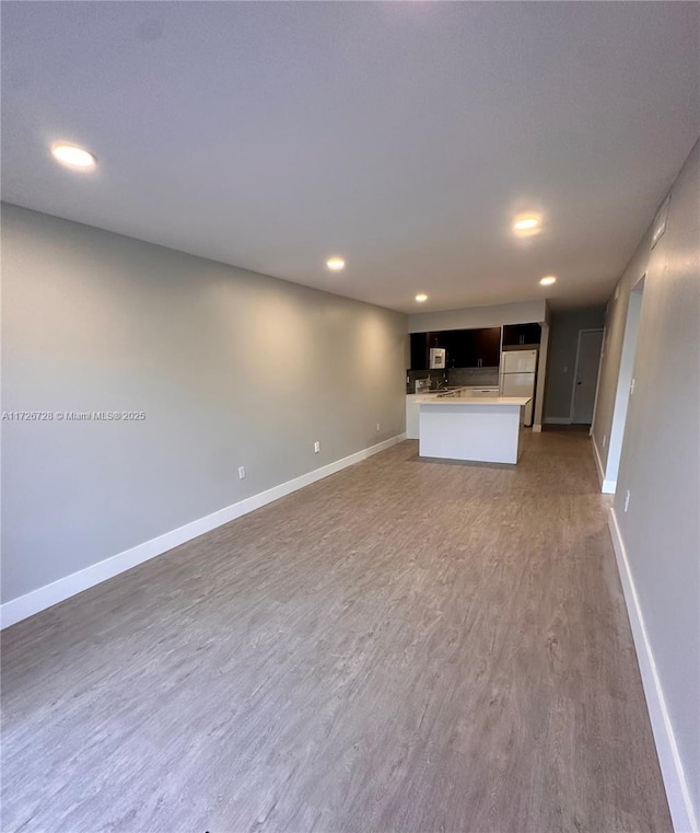 unfurnished living room featuring hardwood / wood-style flooring