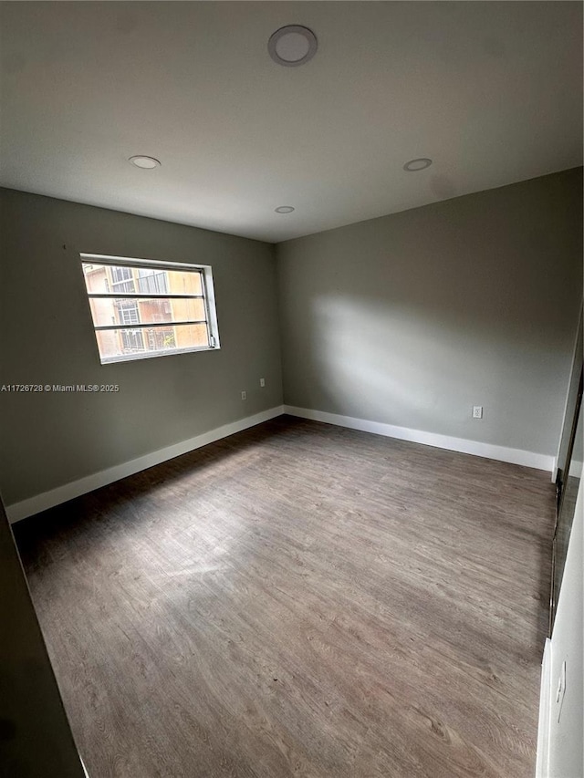 spare room with dark hardwood / wood-style floors