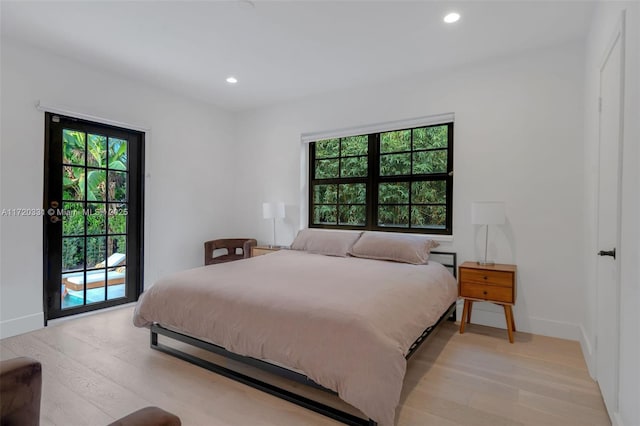 bedroom with access to outside and light wood-type flooring