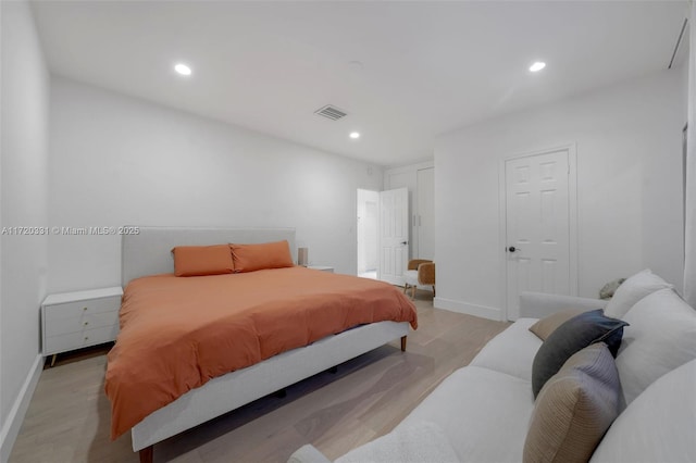 bedroom featuring a closet and light hardwood / wood-style flooring