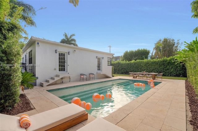 view of pool with an outbuilding and a patio