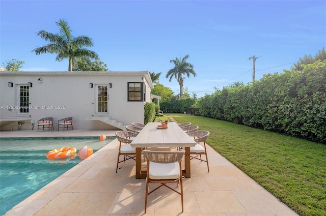 exterior space featuring a patio area and a lawn