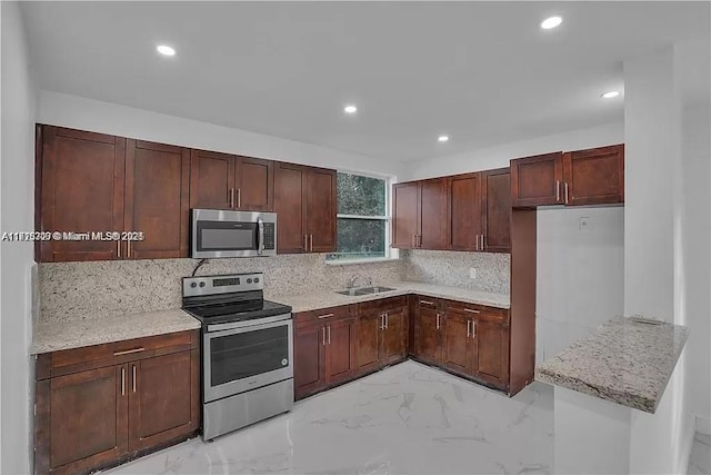 kitchen with tasteful backsplash, light stone countertops, marble finish floor, stainless steel appliances, and a sink