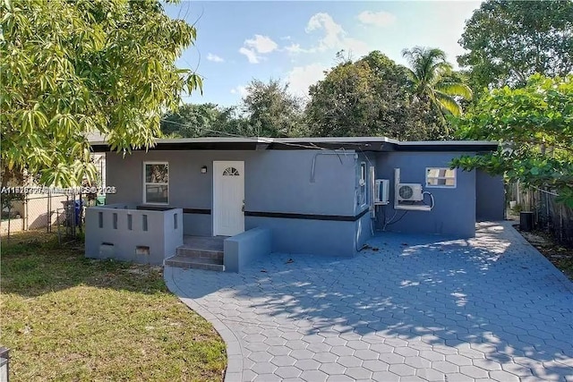 view of front facade featuring fence and stucco siding