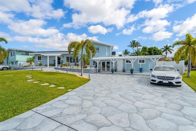 view of front of home featuring a front yard and a pergola