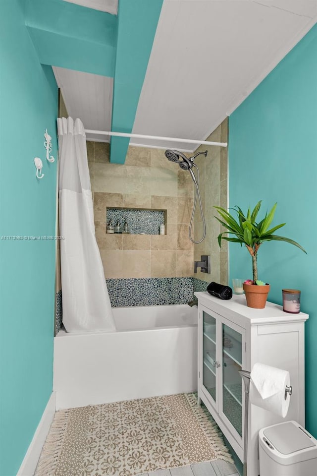 bathroom featuring tile patterned flooring and shower / bath combo with shower curtain