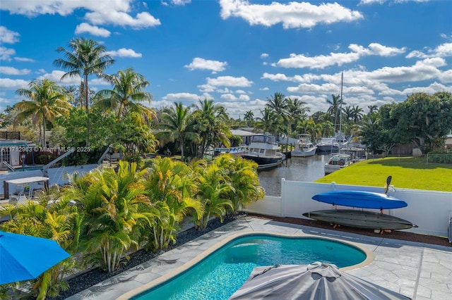 view of pool featuring a water view and a patio