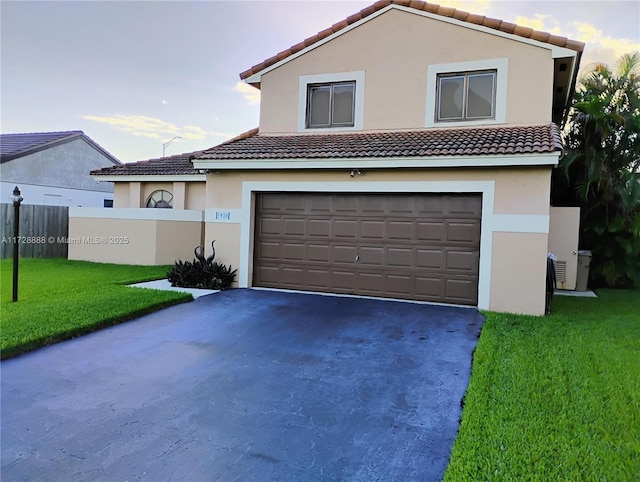 view of front of house with a garage and a front lawn