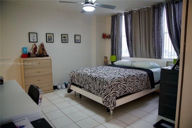 tiled bedroom featuring ceiling fan