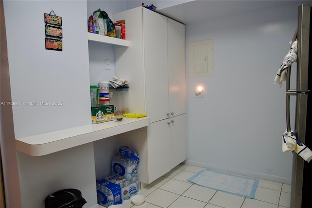 laundry room featuring light tile patterned floors and electric panel