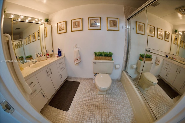 full bathroom with toilet, tile patterned floors, vanity, and shower / bath combination with glass door