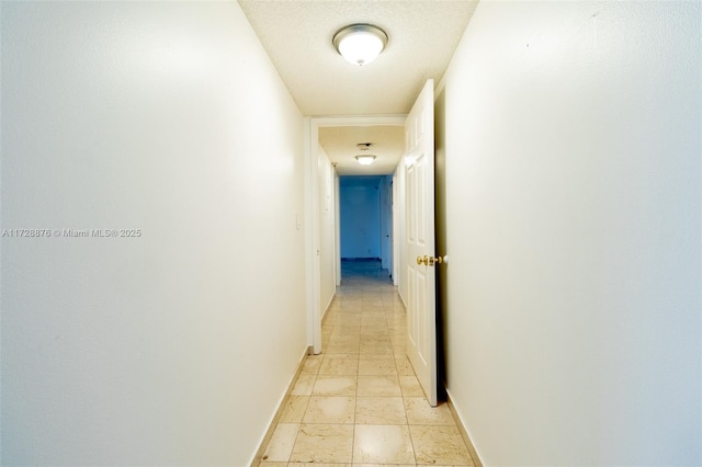 hall with a textured ceiling