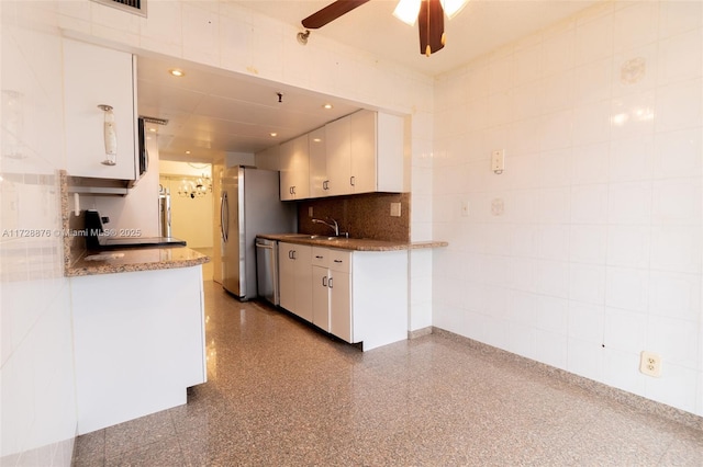 kitchen with white cabinetry, decorative backsplash, dishwasher, and sink