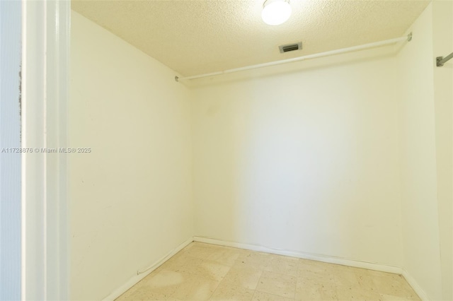 unfurnished room featuring a textured ceiling