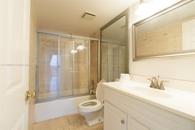 full bathroom with toilet, enclosed tub / shower combo, and vanity