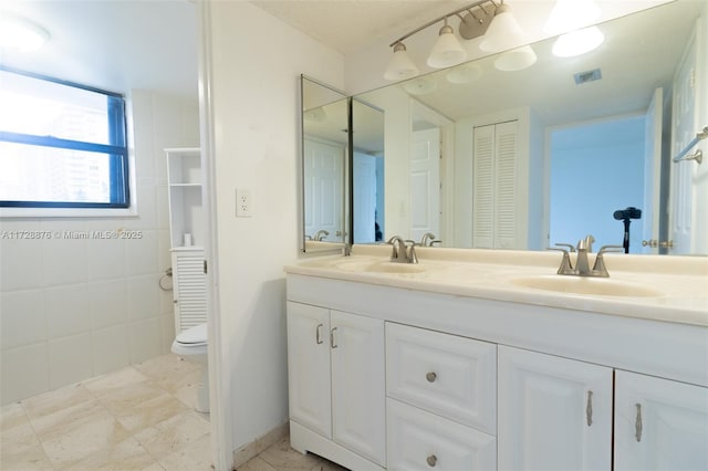 bathroom featuring toilet and vanity