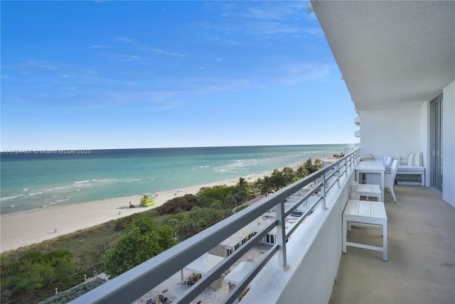 balcony with a beach view and a water view