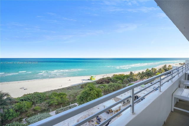 balcony with a view of the beach and a water view