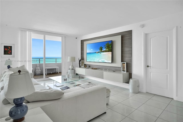 tiled living room featuring a wall of windows