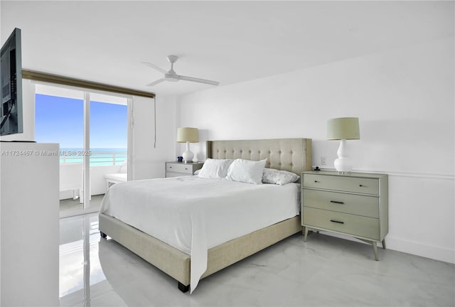 bedroom with ceiling fan, a beach view, and a water view