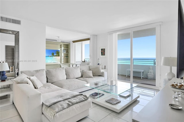 tiled living room with a water view