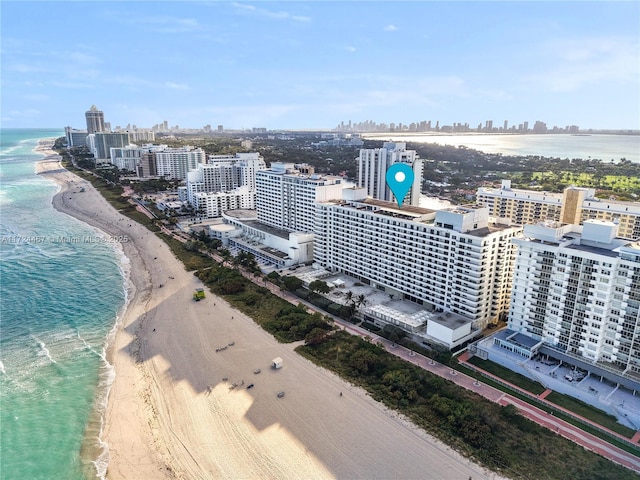 aerial view with a water view and a view of the beach