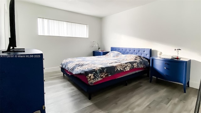 bedroom with hardwood / wood-style flooring