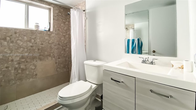 bathroom featuring toilet, vanity, and a shower with curtain