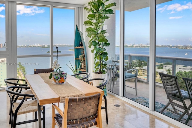 sunroom / solarium with a water view