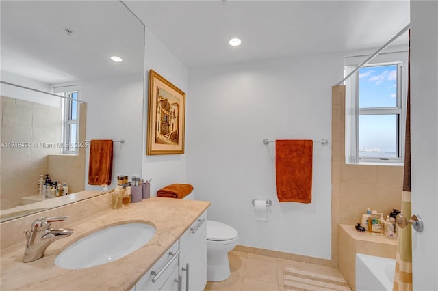 bathroom featuring toilet, vanity, tile patterned flooring, and a shower