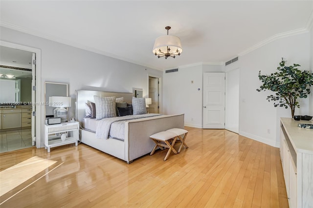 bedroom with ensuite bathroom, a notable chandelier, ornamental molding, and light hardwood / wood-style floors