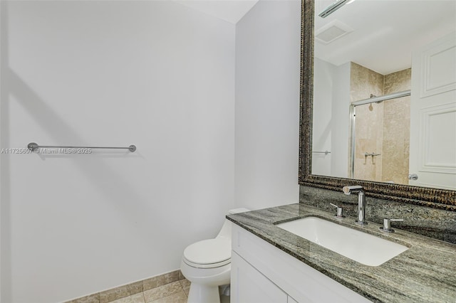 bathroom with toilet, vanity, tile patterned floors, and a shower with door