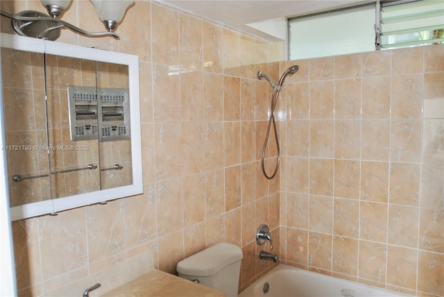 bathroom with toilet and tiled shower / bath combo