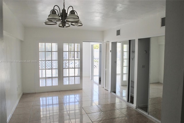 empty room with a notable chandelier