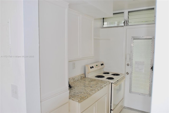 kitchen with white cabinets, white electric range oven, and light stone counters