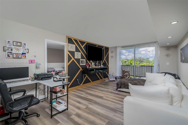 office space featuring floor to ceiling windows and wood-type flooring