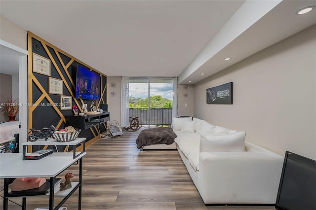 living room featuring hardwood / wood-style flooring and a wall of windows