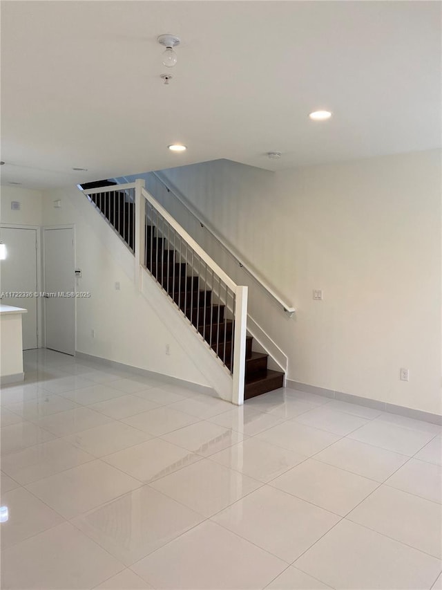 stairway featuring tile patterned flooring