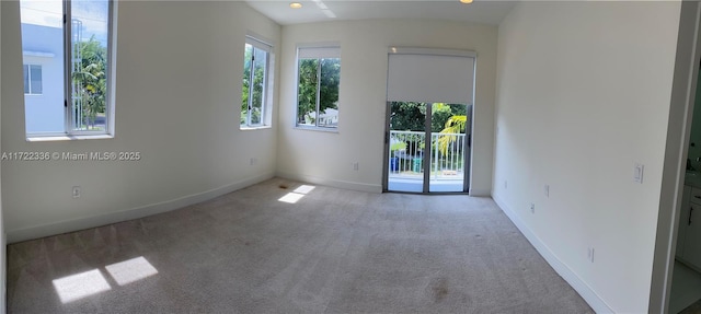 unfurnished room featuring light carpet